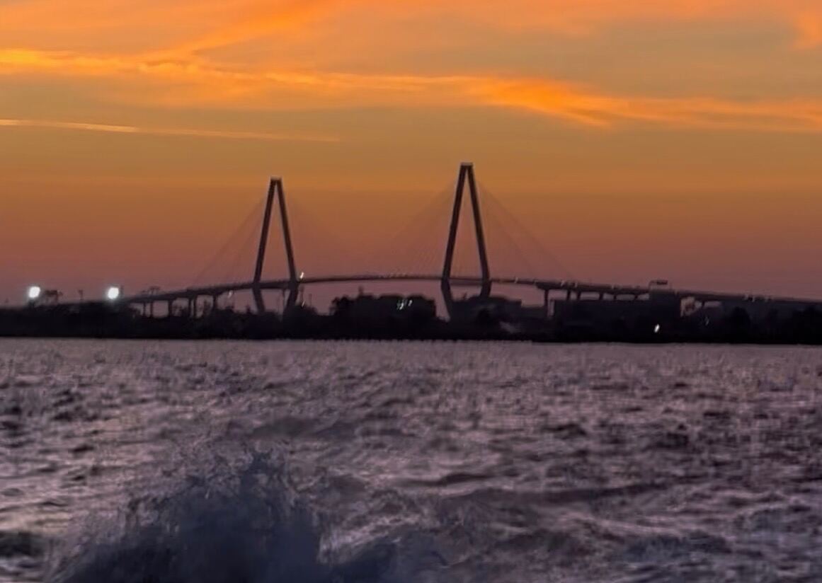 Ravenel Bridge silhouette at sunset from the water
