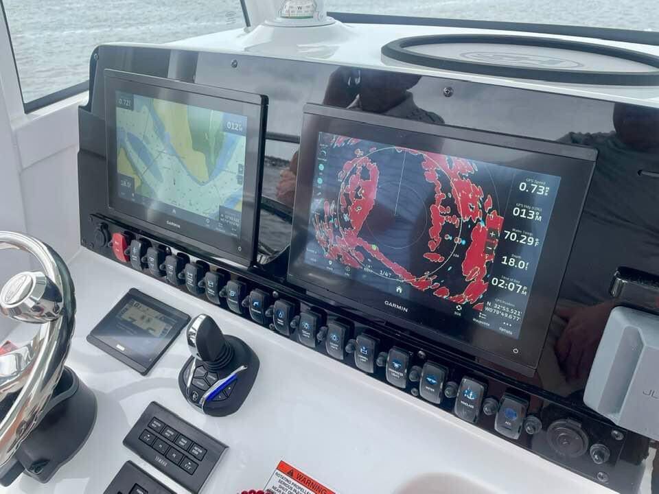 Helm and navigation electronics on the Addi J Charters Sea Hunt during on-water boat training
